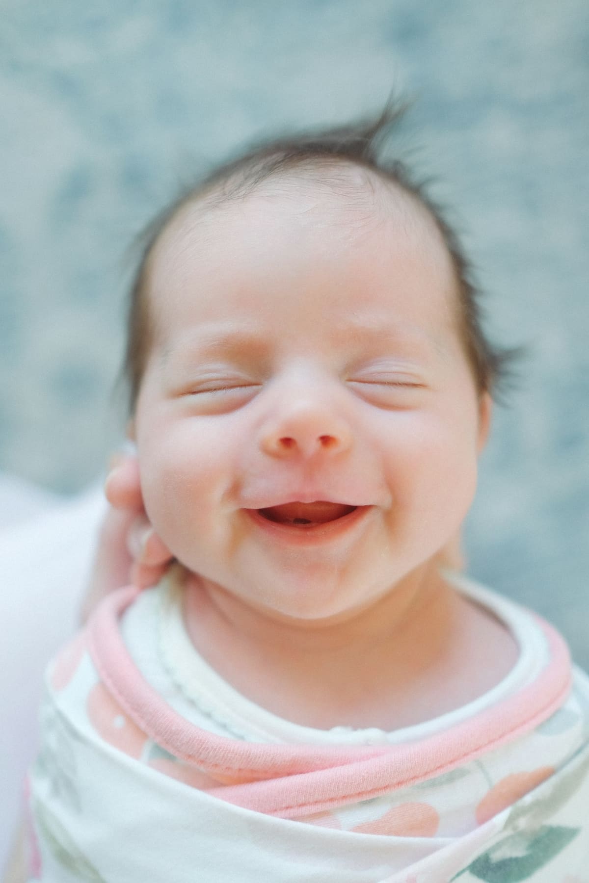 A newborn baby smiling